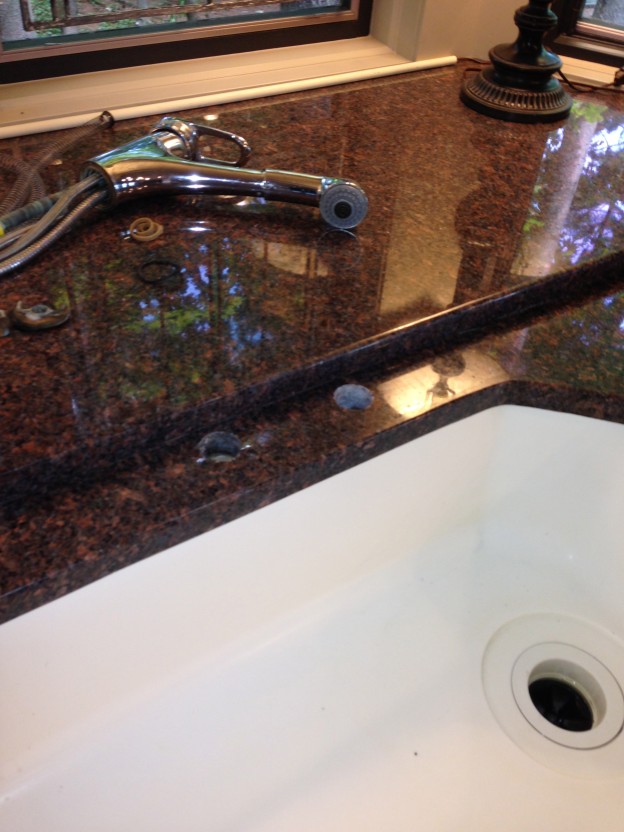 Granite hole drilled for water purification faucet, Traverse City, MI